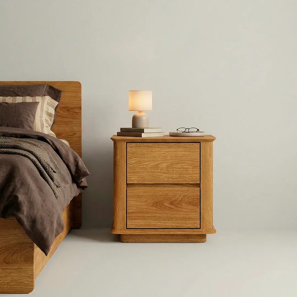Cwellyn — A natural oak bedside table with two spacious drawers.