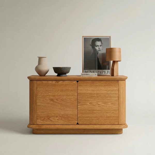Cwellyn Storage — A low natural oak cabinet with smooth, handle-free doors.